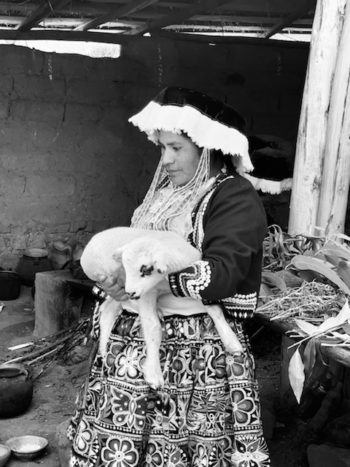 Sacred Valley, Peru - Peruvian woman holding a sheep in Peru on a Knowmad Trip 