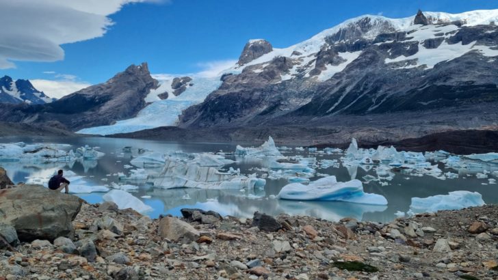 Knowmad traveler sitting near a glacier