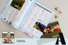 Jordan Harvey wins a spot on Travel + Leisure A-List 2023. Photo of an open magazine with a Knowmad Adventures catalog and 3 gold clips.