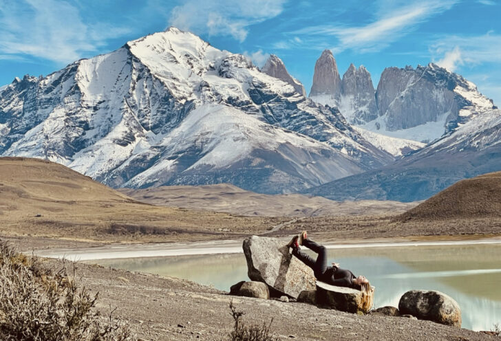 Knowmad Traveler poses in front of a lake in Torres del Paine, Chile