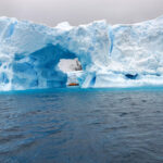 Raft floats through cave in Antarctica on an Antarctica and Patagonia exploration.