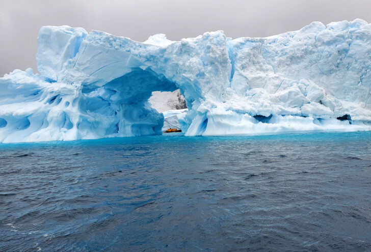 Raft floats through cave in Antarctica on an Antarctica and Patagonia exploration.