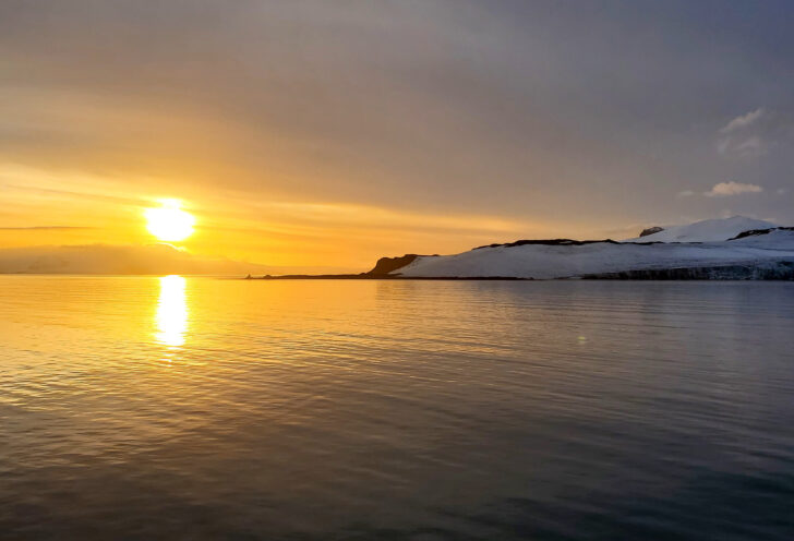 Knowmad Adventures traveler snaps a shot of a sunset over the ocean on their Antarctica and Patagonia exploration. 