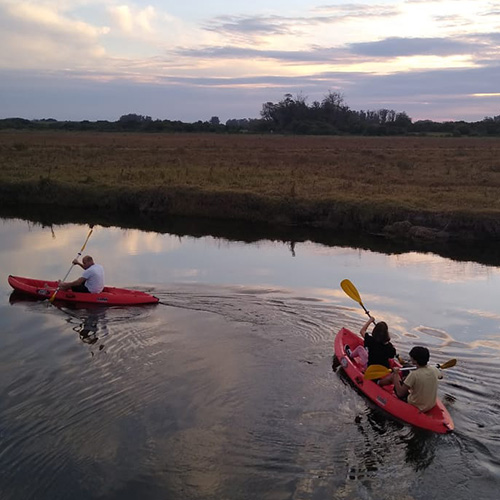 Group during a sunset kayak during a luxury Uruguay travel itinerary with Knowmad Adventures. 